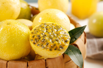 Fresh Golden Passion Fruit from Guangxi Hainan China in Wooden Basket with Tropical Leaves