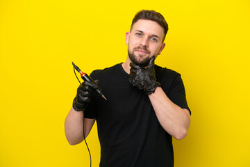 Tattoo artist man isolated on yellow background thinking an idea while looking up