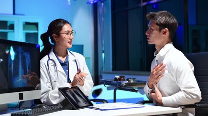 Professional female doctor explaining chest X-ray results to patient in modern clinic, medical consultation, radiology, healthcare - Powered by Adobe