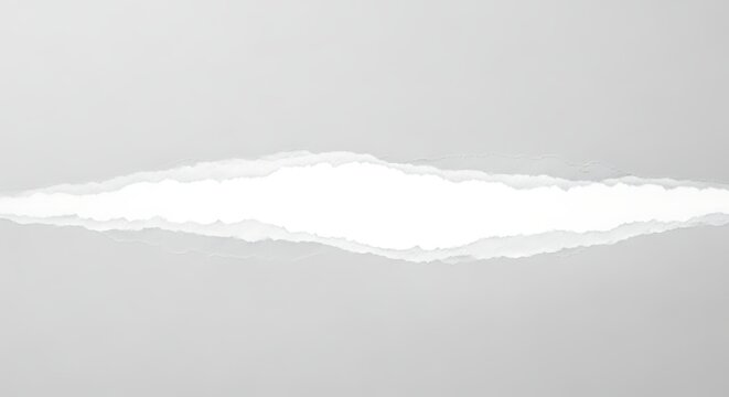 Torn white paper with ragged edges and a bright white background isolated on white background