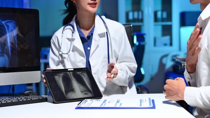 Professional doctor consulting patient in modern clinic with digital X-ray and tablet healthcare concept - Powered by Adobe