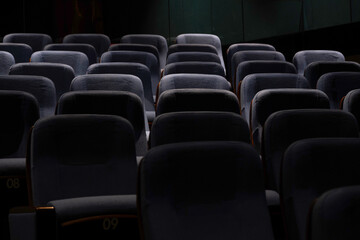 Karachi, Pakistan - April 10, 2025: A captivating view of multiple rows of empty seats under dim lighting, Ideal for concepts related to education, presentations, cinema, events, or public gatherings.