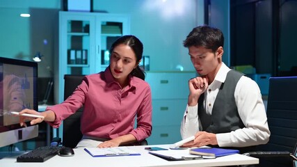 Professional Asian colleagues working together in modern office, discussing data and strategy, teamwork and corporate collaboration concept. - Powered by Adobe