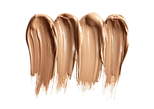 Swatches of beige foundation makeup on a black background