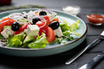 greek salad with fresh ingredients on plate serving on table in restaurant