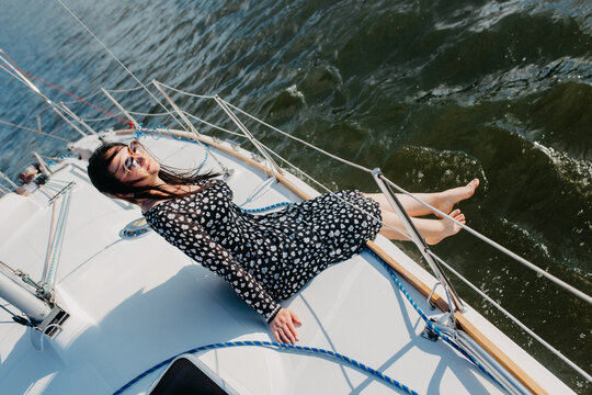 Woman relaxing on sailboat enjoying summer vacation