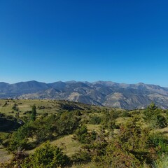 Azure Sky and Greenery Under the Fascinating Mountain View.