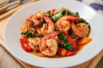 Stir fried spicy shrimp in a white plate