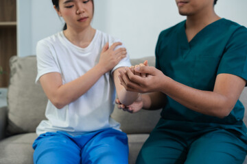 Help of a therapist trainer during a rehabilitation session. woman doing exercise at clinic with...