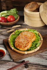 Chinese Sesame Seed Buns Beijing Style Traditional Food with Steamer Basket and Chopsticks