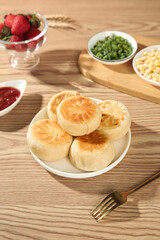 Crispy Pork Buns Asian Dim Sum with Fresh Strawberries and Condiments on Wooden Table