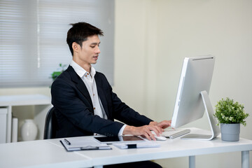 Male office worker working on computer in office