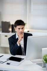 Male office worker working on computer in office