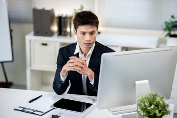 Male office worker working on computer in office
