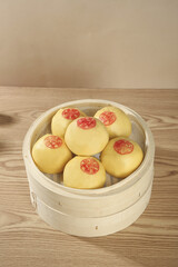 Chinese Steamed Pumpkin Buns with Fortune Symbols in Bamboo Steamer - Traditional Shandong Cuisine