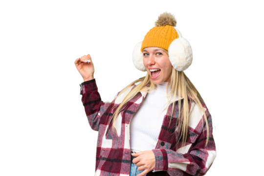 Young pretty blonde woman wearing winter muffs over isolated chroma key background making guitar gesture
