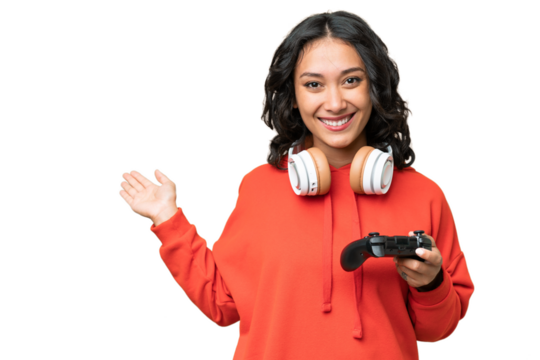 Young Argentinian woman playing with a video game controller over isolated background extending hands to the side for inviting to come - Powered by Adobe