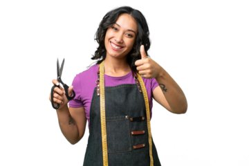 Young seamstress argentinian woman over isolated background with thumbs up because something good has happened