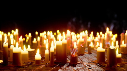 A sea of candles burns softly in the dark, casting a warm glow. The dance of their flames creates an enchanting atmosphere, bringing peace and reflection to all who gaze upon them.