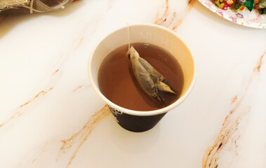 Tea brewing in a cup with a tea bag