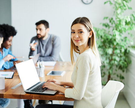 Portrait of a group of young business people having a meeting in the office. Teamwork and success concept, portrait of a smart young businesswoman