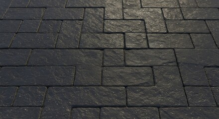 Dark textured stone pavers are arranged in an alternating rectangular pattern catching light on their rough surfaces