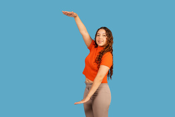 Young woman gesturing, showing large amount or size