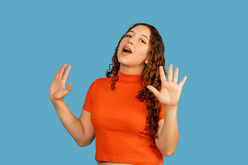 Young woman singing performing with expressive hands gesture