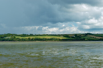 Calm water reflects the dramatic sky above.