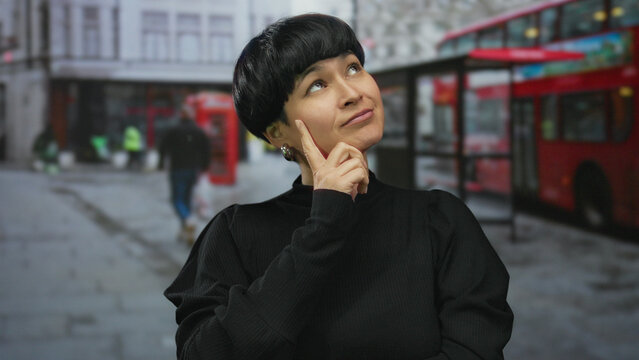 Woman pondering street cityscape with iconic red bus and phone booth suggesting busy urban lifestyle and modern city setting reminiscent of london. - Powered by Adobe
