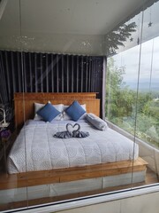 Place the bed against the glass wall to provide a view.