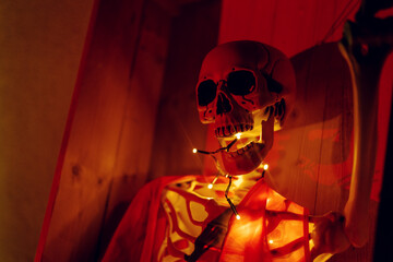 Night Halloween background. Halloween skeleton for decorated house. Scary decorated front yard of American house. Caricature or something. Halloween background. Autumn holiday of Halloween.