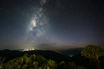 Majestic night sky with Milky Way galaxy full of stars over serene mountain landscape. tranquil...