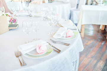 Elegant Table Setting for Wedding or Celebration with Pink Flowers and Napkins