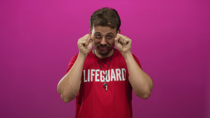 Young hispanic man lifeguard wearing red lifeguard shirt and whistle miming crying with fists by...