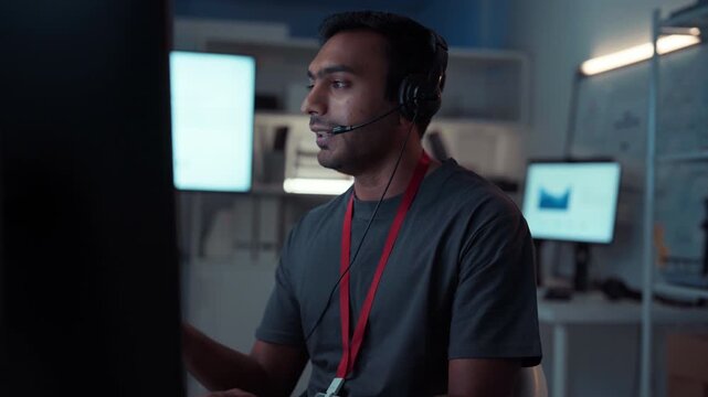 Young adult indian man wearing headset remote work online technical support business customer service at home