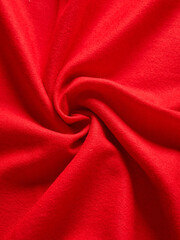Obraz premium Bright Red Fabric Showing a Swirling Textured Pattern Up Close