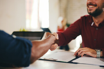 Close-up of a successful handshake between two diverse businessmen, one Caucasian and one African...