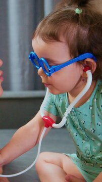 young child practicing medical play, little explorer roleplaying as healthcare professional with toys