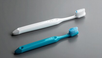 Four upright toothbrushes with white necks and colored handles on textured gray surface, evoking hygienic symmetry and everyday design.