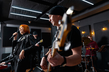 Energetic Band Performing Music in a Modern Studio Setting