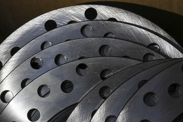Close up abstract industrial background of layered metal steel disc with hole. powerful and precise mechanical pattern from circular parts creating textured composition
