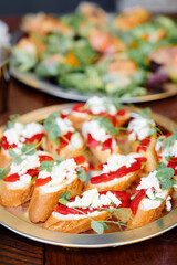 Colorful crostini bites topped with red pepper, crumbled cheese, and fresh herbs make a vivid appetizer platter perfect for gatherings, celebrations, or catered events.