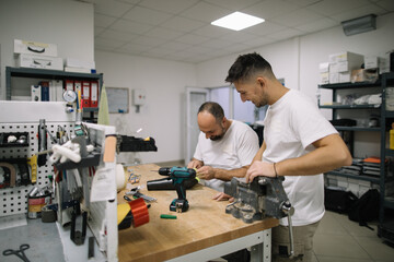 Coworkers working together in workshop