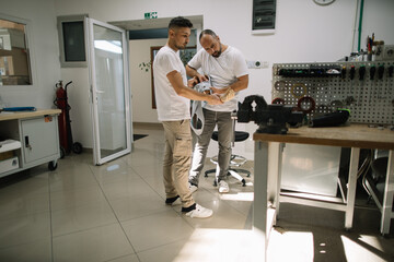 Two prosthetists testing prosthetic device in lab