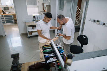 Two prosthetists testing prosthetic device in lab
