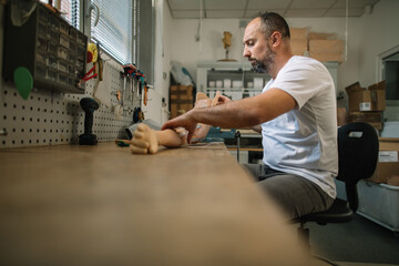 Skilled craftsman adjusting prosthetic arm components
