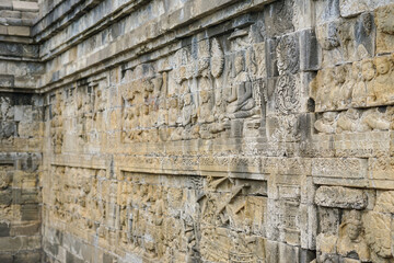 Ancient stone reliefs of Borobudur Temple in sunlight