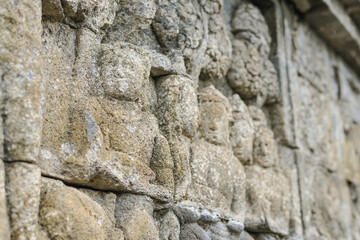Ancient stone reliefs of Borobudur Temple in sunlight