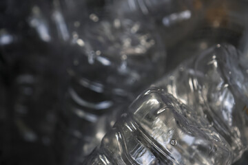 Macro close up of crumpled plastic bottle waste creating an abstract texture. background highlighting environmental pollution and urgent need to recycle for sustainability